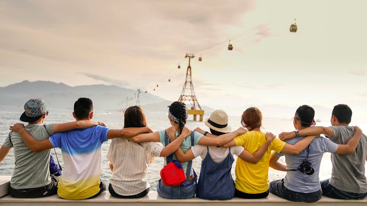 A group of people standing together, arms around each other